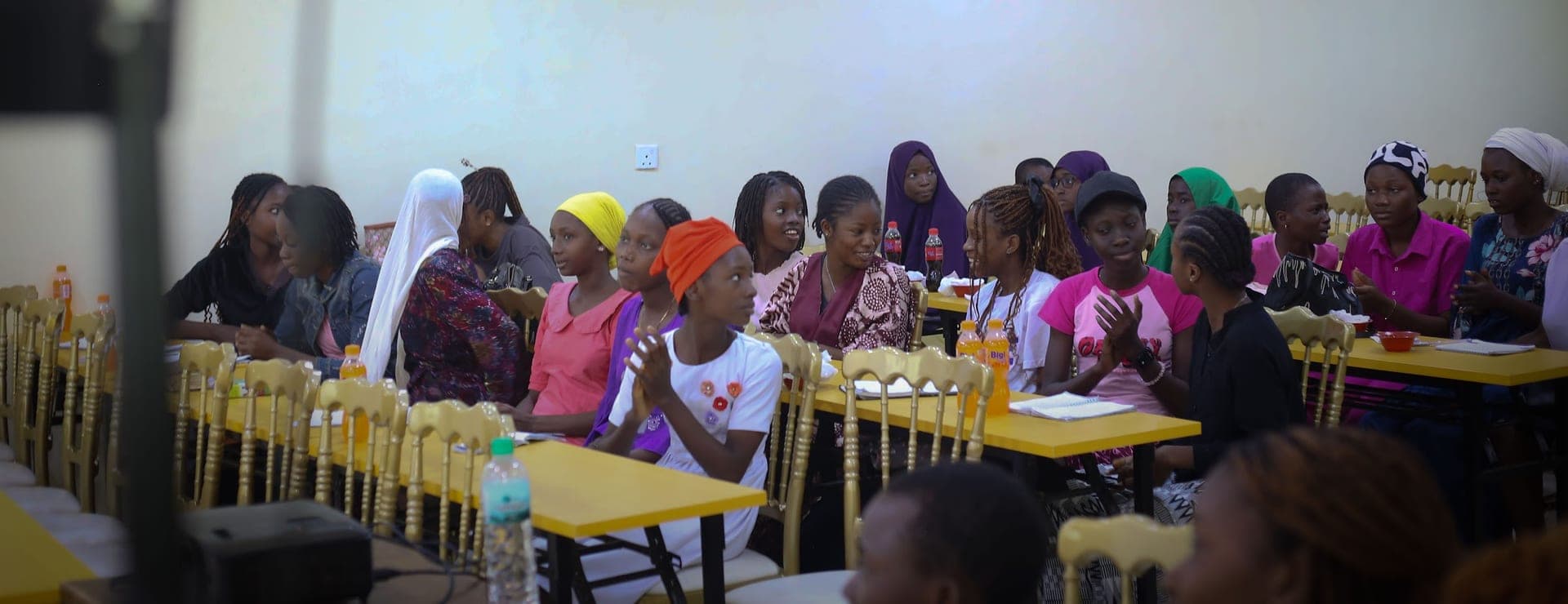 Teenagers seated together, listening during a Sunflower Foundation session