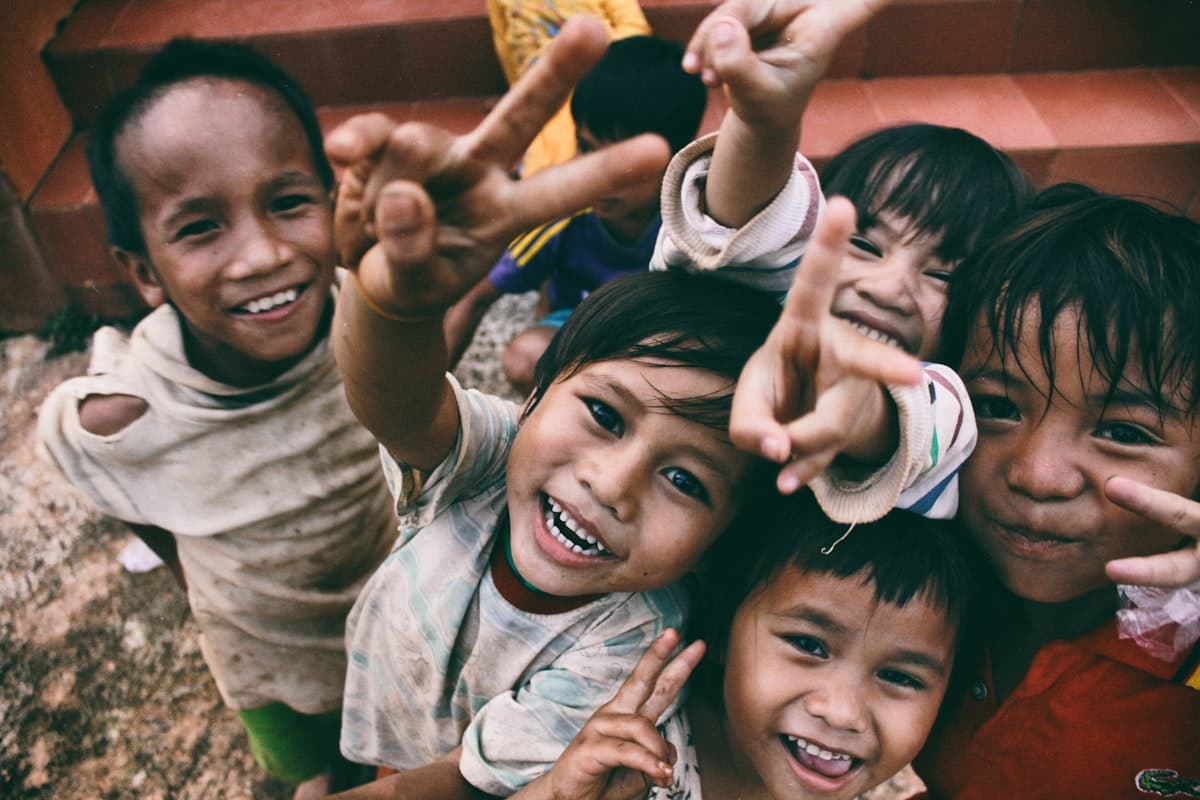 A group of smiling children playing together outdoors
