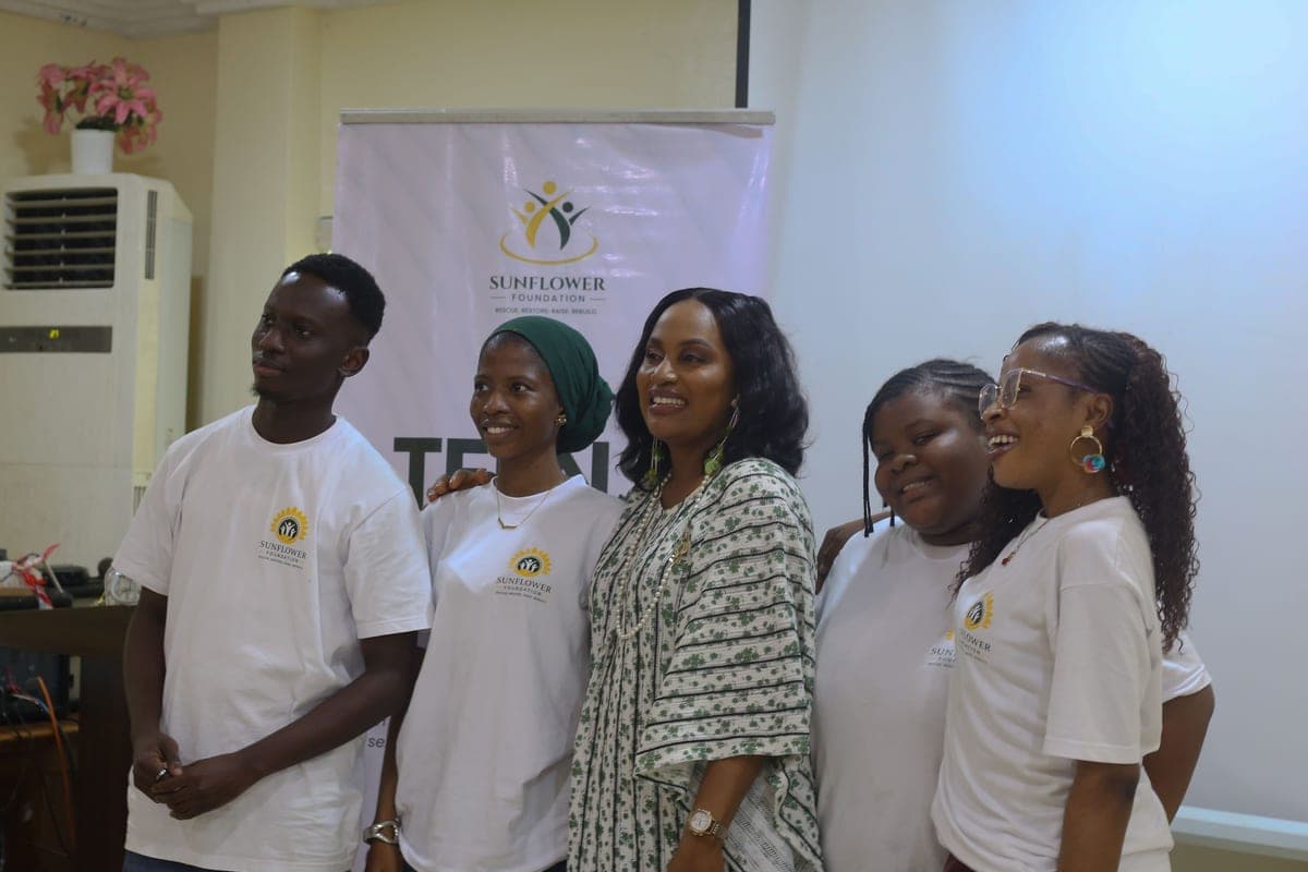 The Sunflower Foundation team and volunteers together beneath the foundation banner